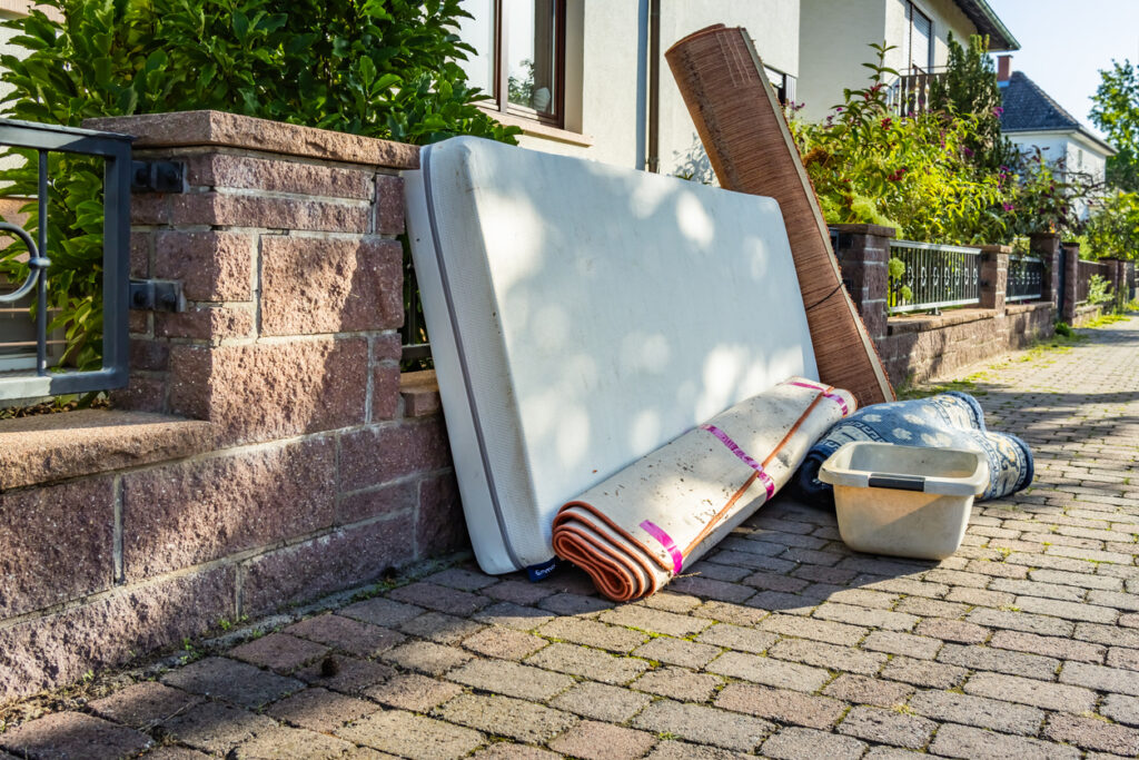 junk removal concept, miscellaneous rubbish items put on a street for council bulk waste collection, bulky waste and waste management