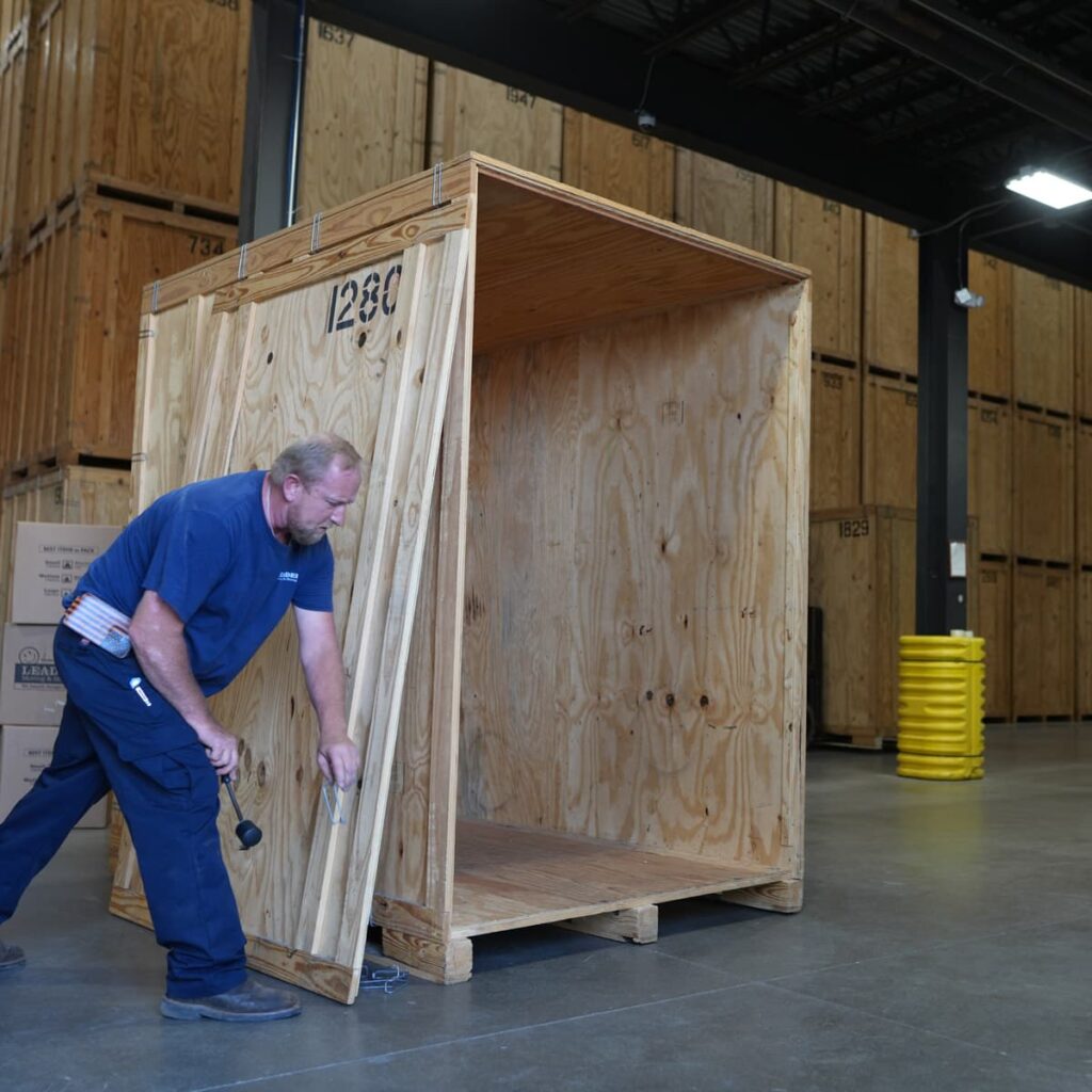 A Leaders Moving & Storage Co. team member expertly constructs a custom crate for a commercial business
