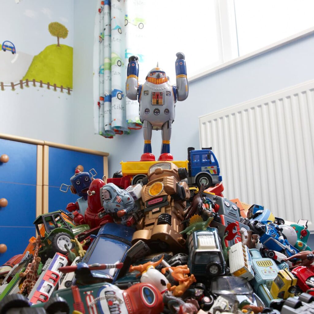 A large pile of old toys in a children's bedroom